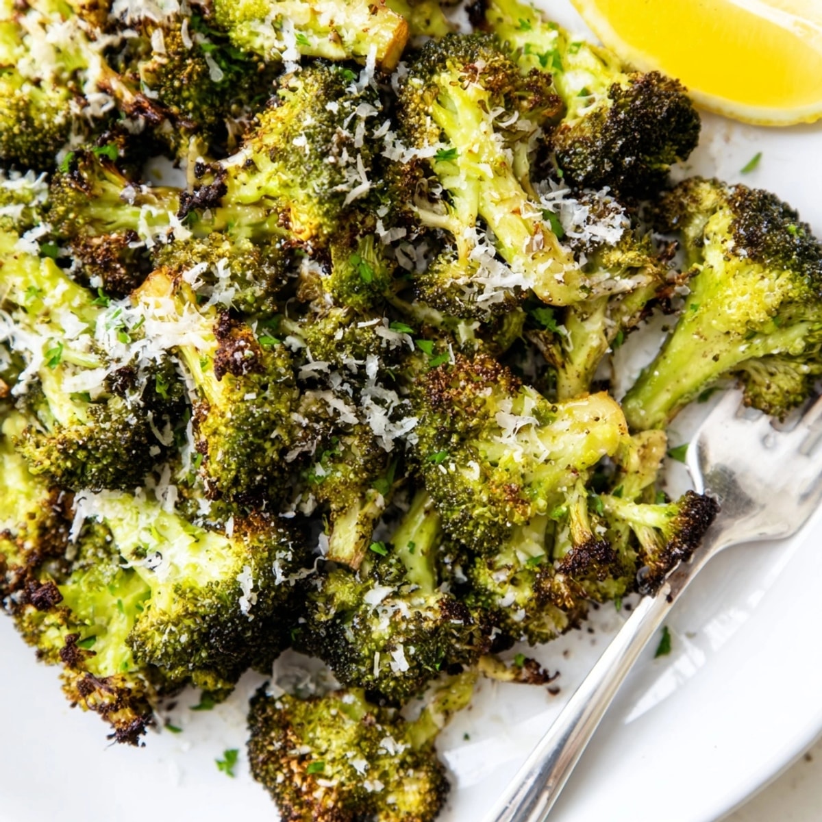 Close-up of freshly baked Garlic Parmesan Broccoli, flecked with herbs, ready to serve.