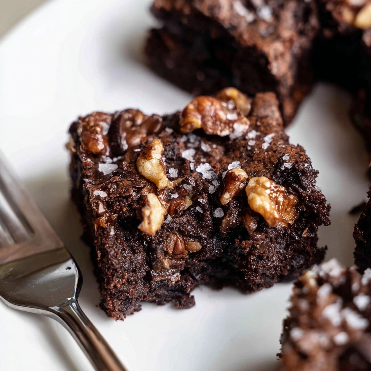 Warm, dark Almond Flour Brownies in a parchment-lined pan, cooling after baking; gluten-free dessert.