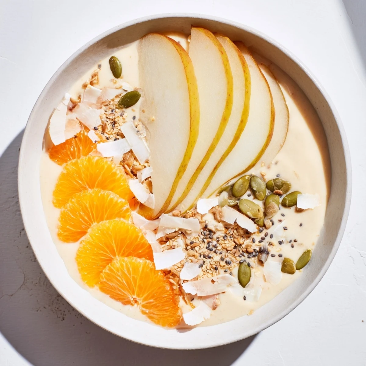 Perfectly blended Citrus Smoothie Bowl, topped with coconut flakes, making a delicious and healthy treat.