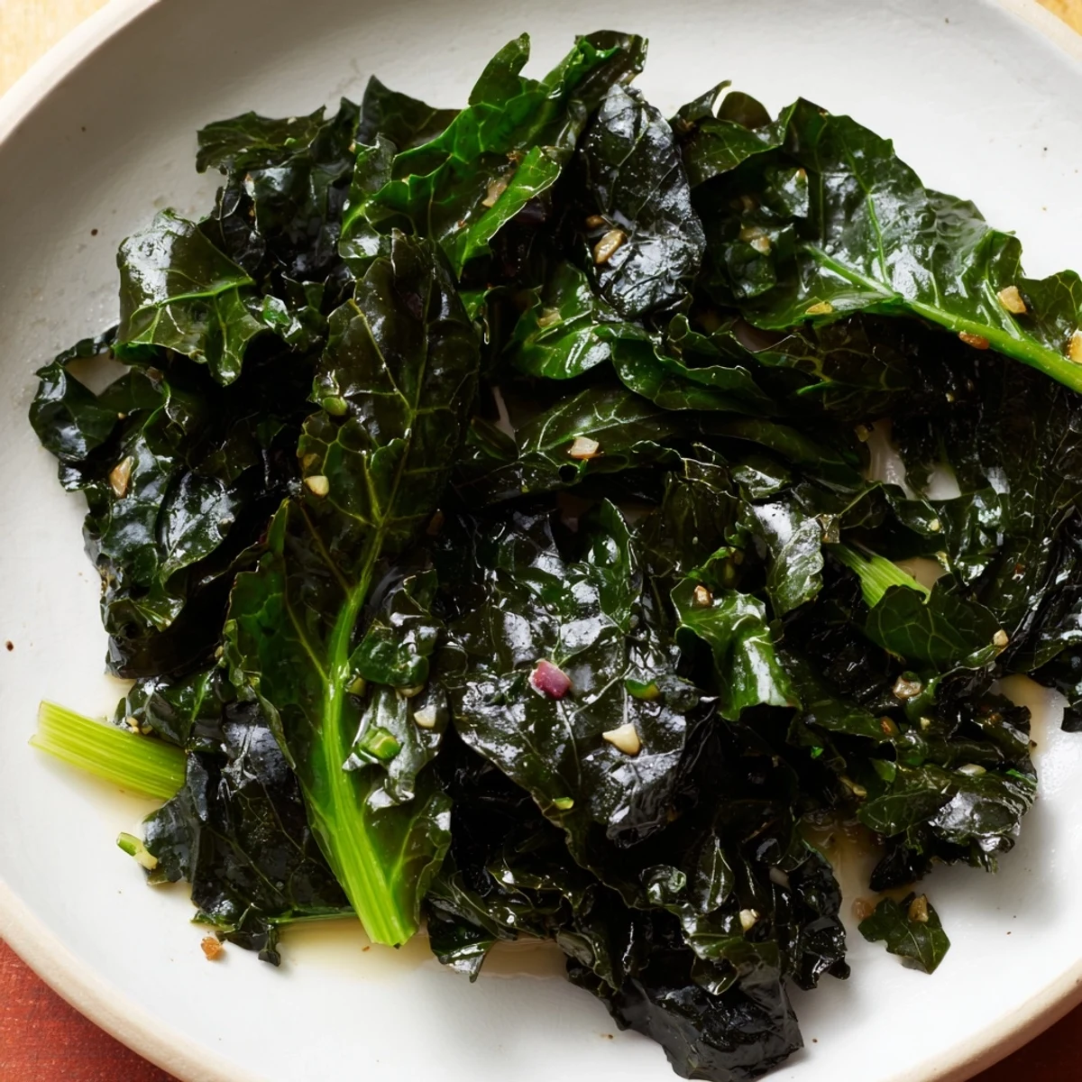Savory Braised Winter Greens, glistening and ready, served alongside roasted chicken for a meal.