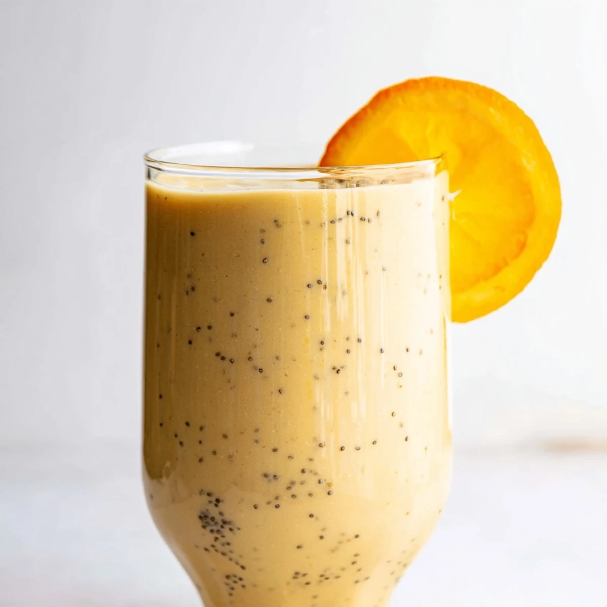 Bright orange Citrus Ginger Smoothie, creamy and refreshing, perfect for a winter morning boost.
