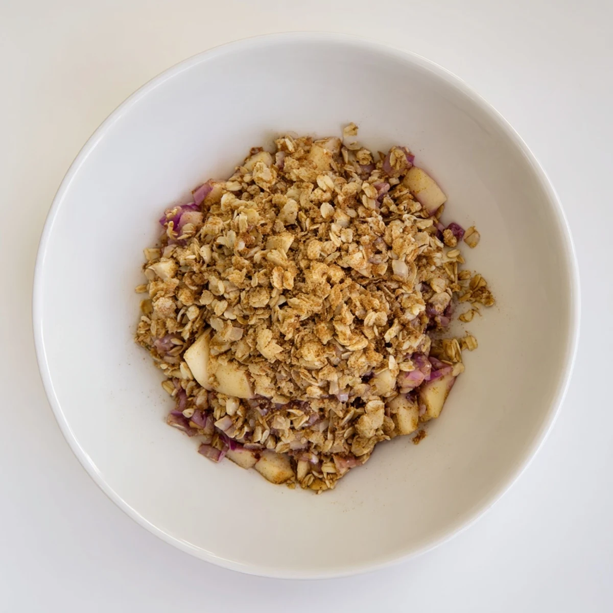 A close-up of golden, baked Braised Red Cabbage with a crisp oat topping; a hearty side dish.