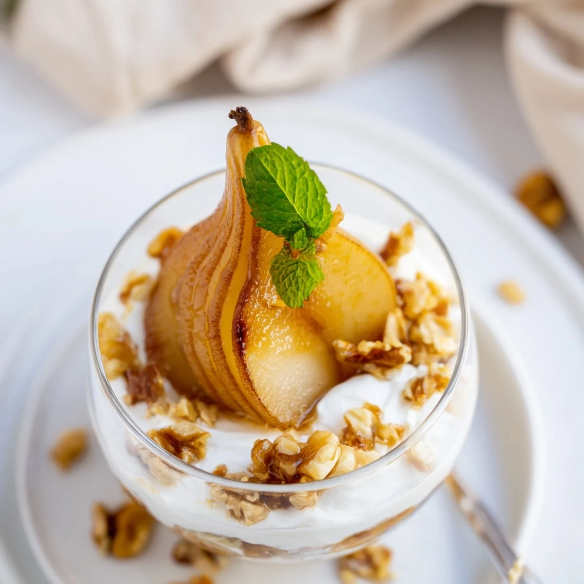 Warm, comforting Maple-Kissed Pear Parfait with caramelized pears, served in elegant glass dishes.