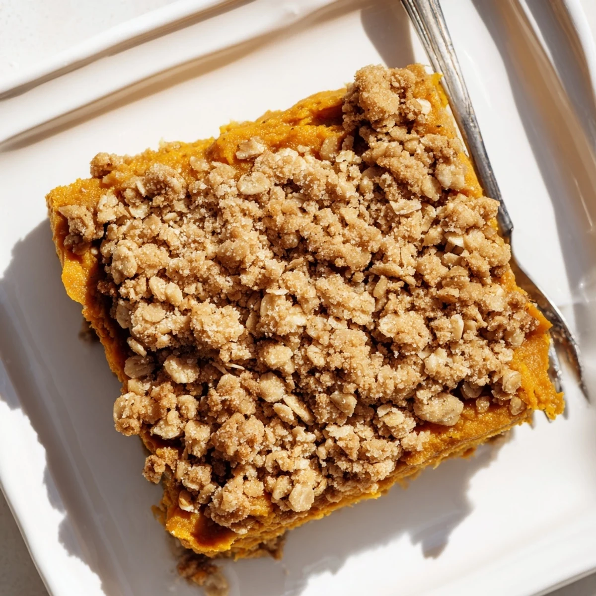 A warm and inviting image of freshly baked pumpkin spice crumble in a glass baking dish.