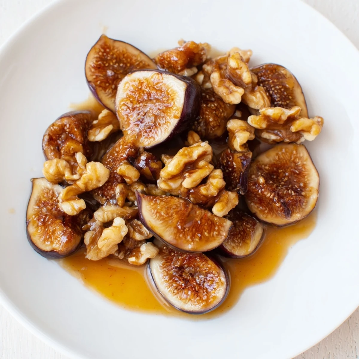 Rich Fig and Walnut Compote spooned onto a cheese platter, paired with crackers and fresh fruit slices.