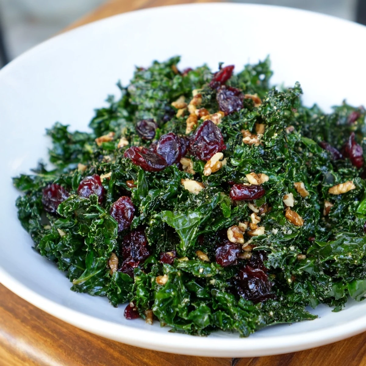 Freshly sautéed Garlic Sautéed Kale with Cranberries on a white plate, perfect for a healthy vegan side dish.
