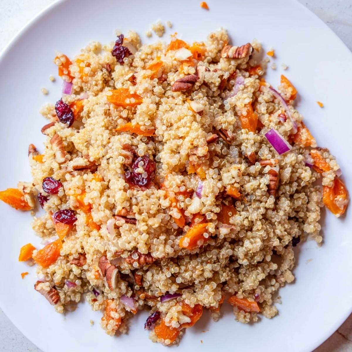 Maple Orange Quinoa Pilaf with dried cranberries and diced carrots ready for a light vegetarian main course.