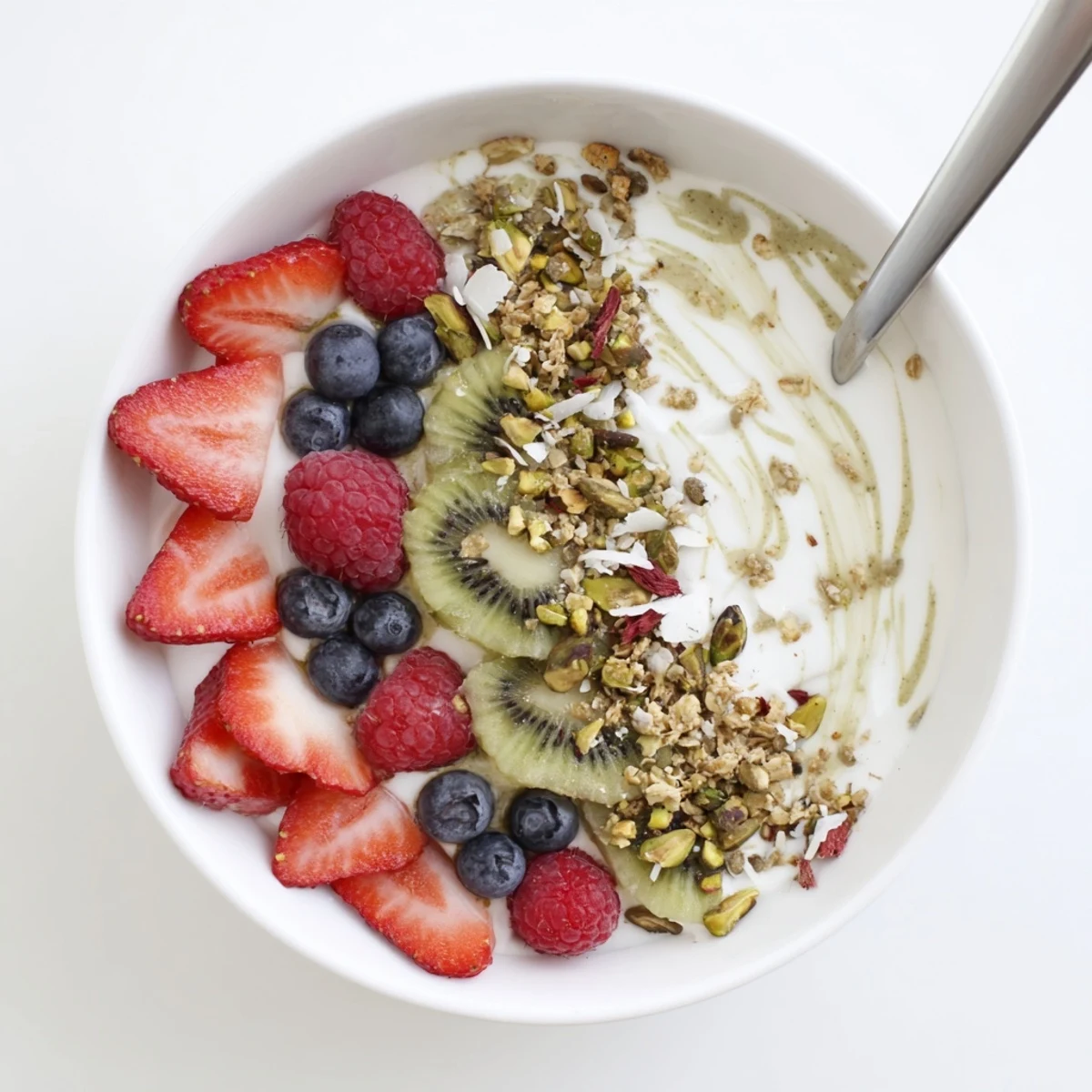 A vibrant pistachio cream yogurt breakfast bowl with kiwi slices and chia seeds.