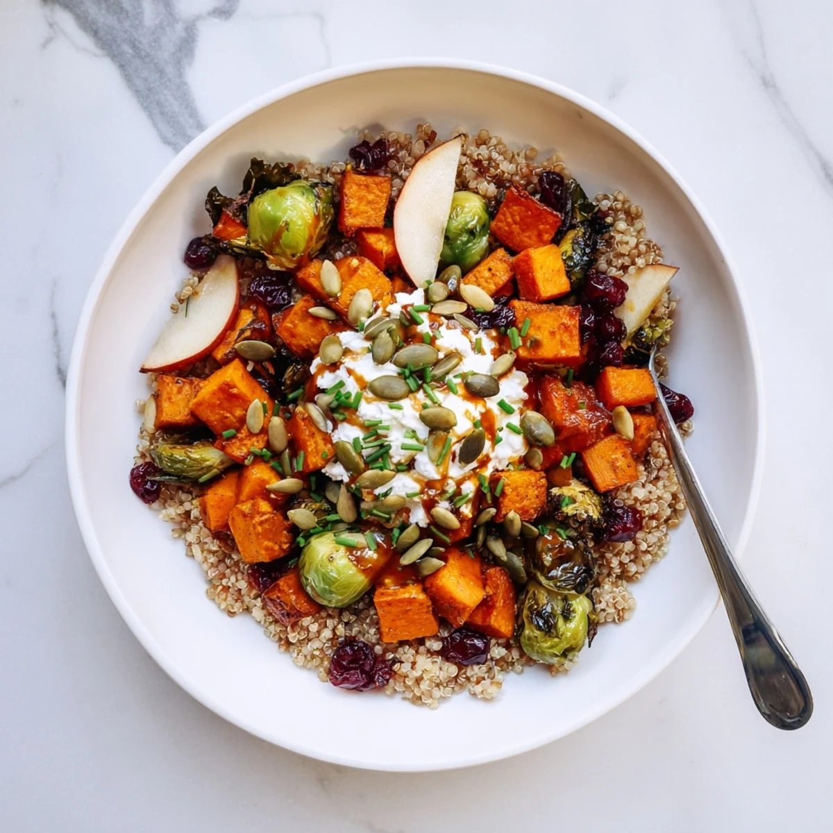 A vibrant Savory Cottage Cheese Harvest Bowl with roasted sweet potatoes and Brussels sprouts, garnished with pumpkin seeds.