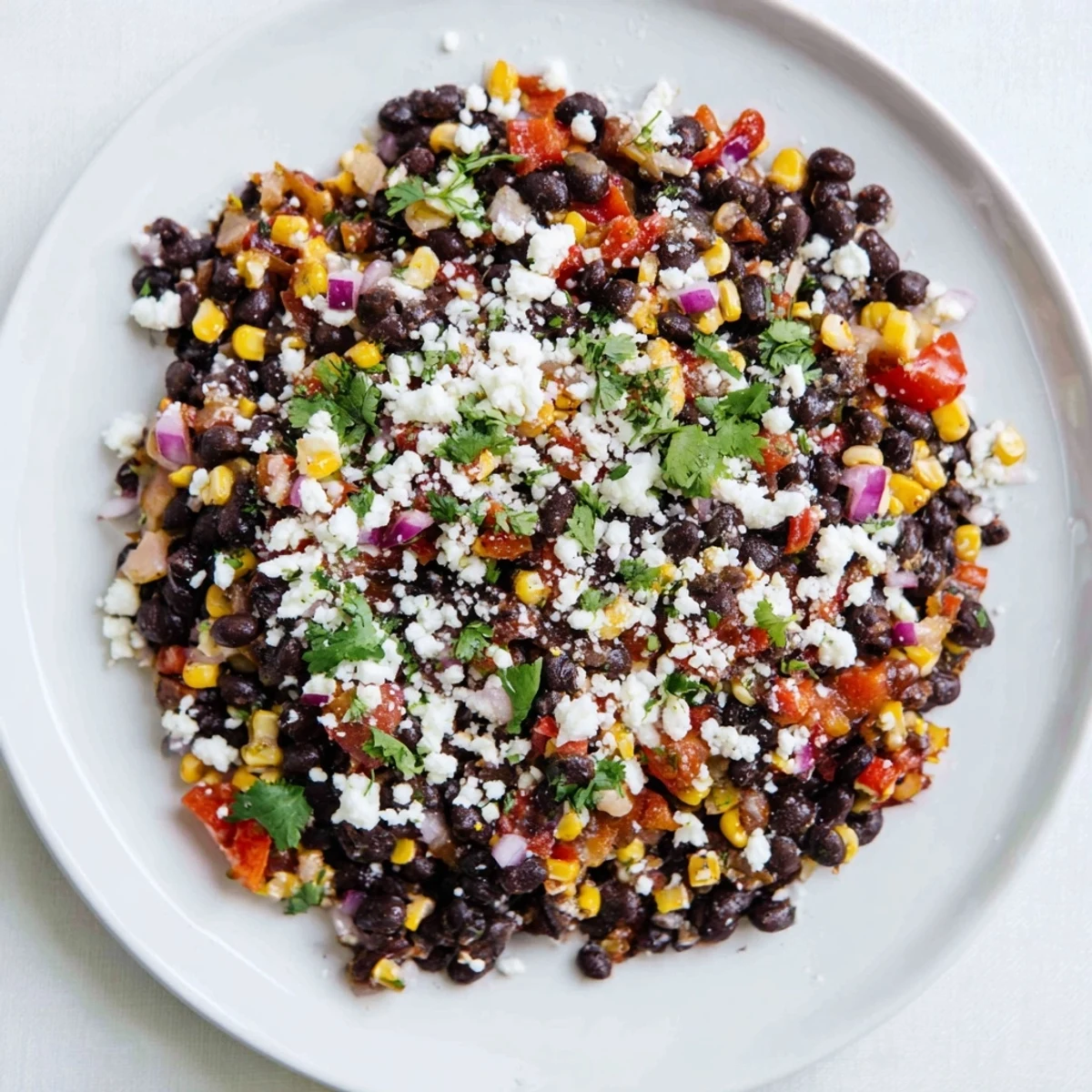 One-pan vegetarian smoky chipotle black bean skillet featuring colorful peppers sweet corn and lime wedges