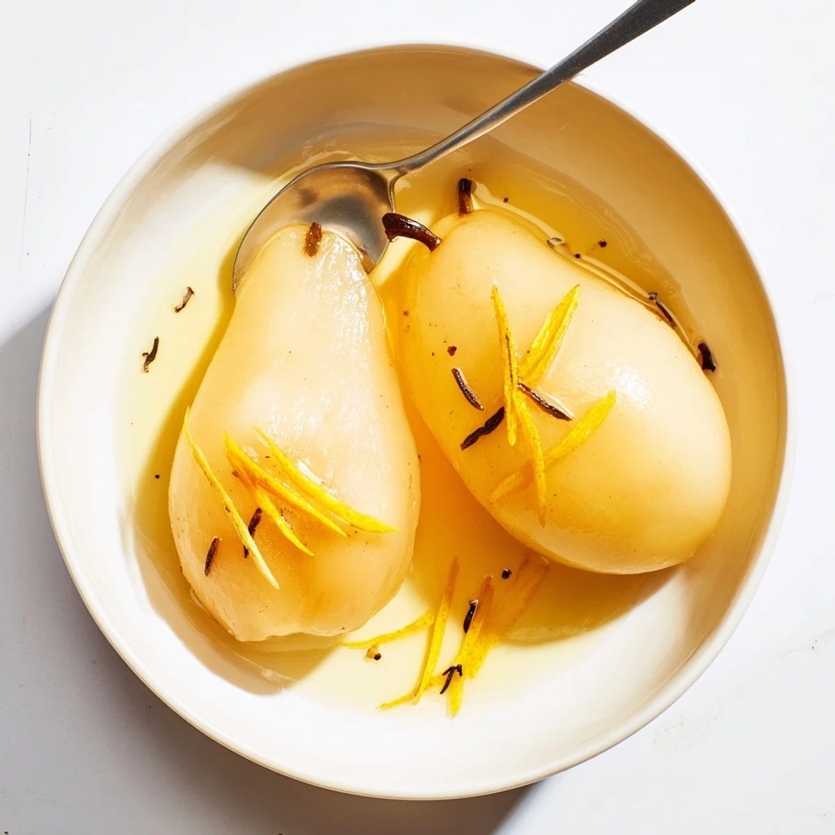 Ripe halved pairs steeped in aromatic vanilla bean and fresh citrus zest sauce