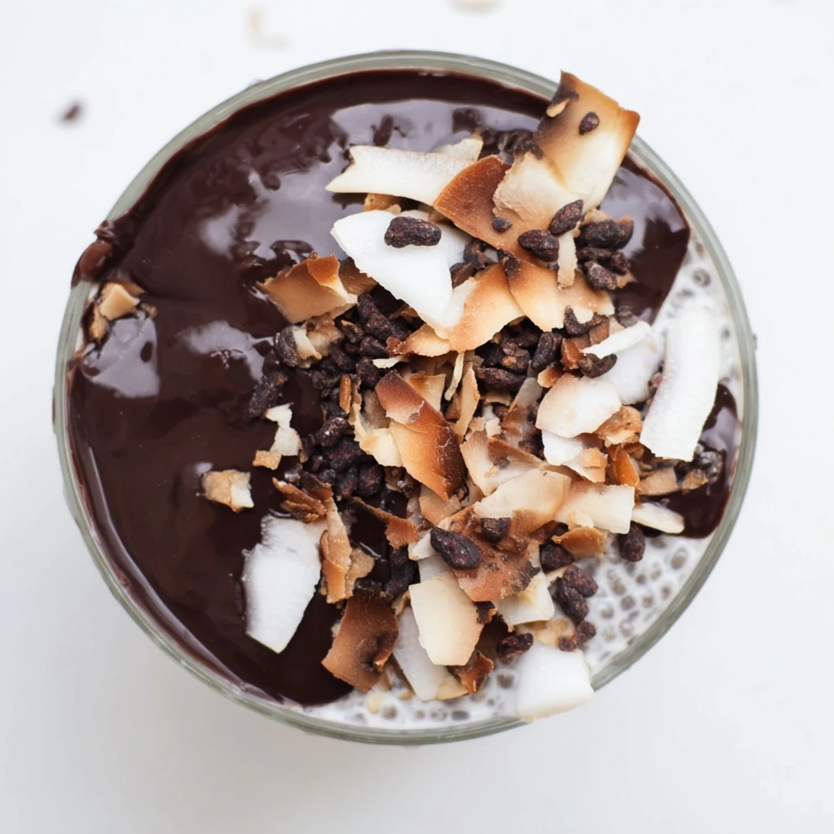 Rich dark chocolate coconut chia delight served in elegant bowl with whipped texture and berry garnish