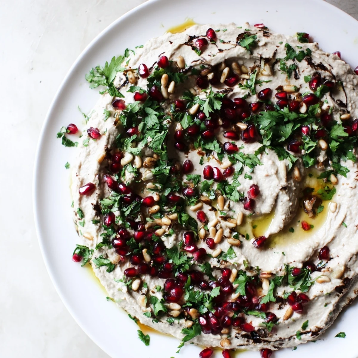 Golden roasted eggplant topped with creamy tahini sauce and fresh parsley garnish