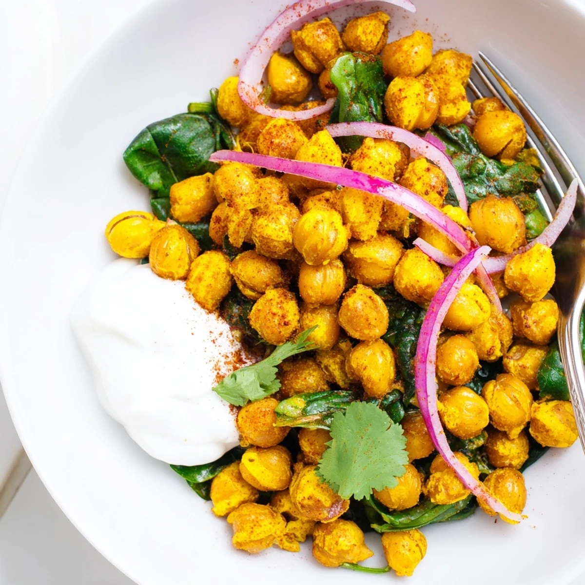 Mediterranean crispy turmeric chickpea skillet served with yogurt dollop and fresh herbs