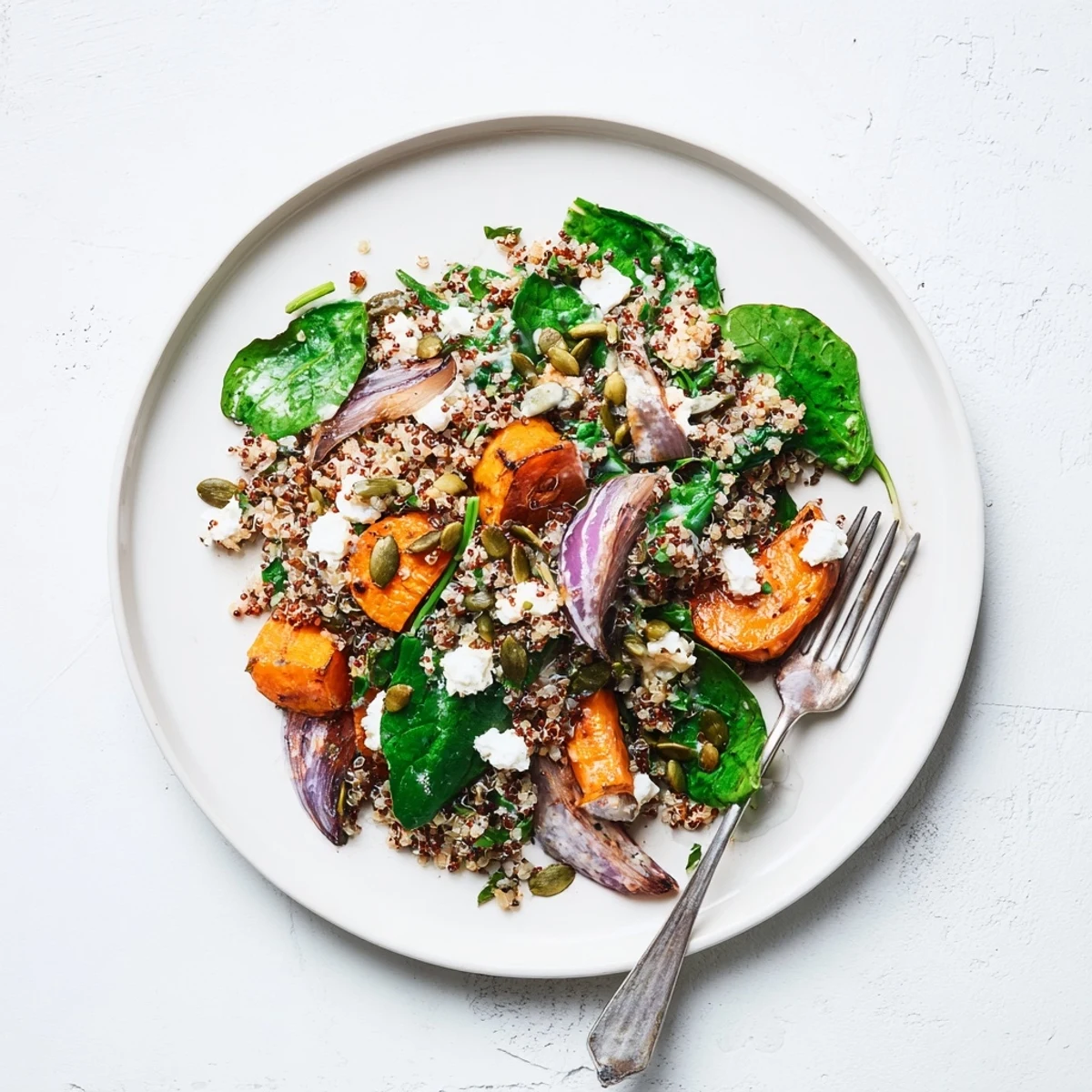 Golden roasted carrots and fluffy quinoa tossed in creamy lemon tahini dressing with fresh spinach