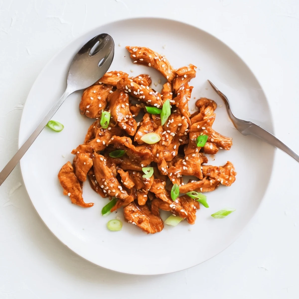 Savory slow-cooked Crockpot Teriyaki Chicken served over steamed white rice with sesame seeds
