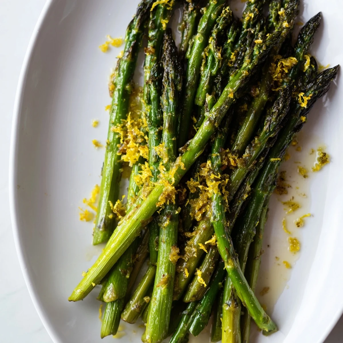 Oven-roasted green asparagus seasoned with garlic and finished with grated lemon zest for a bright side dish