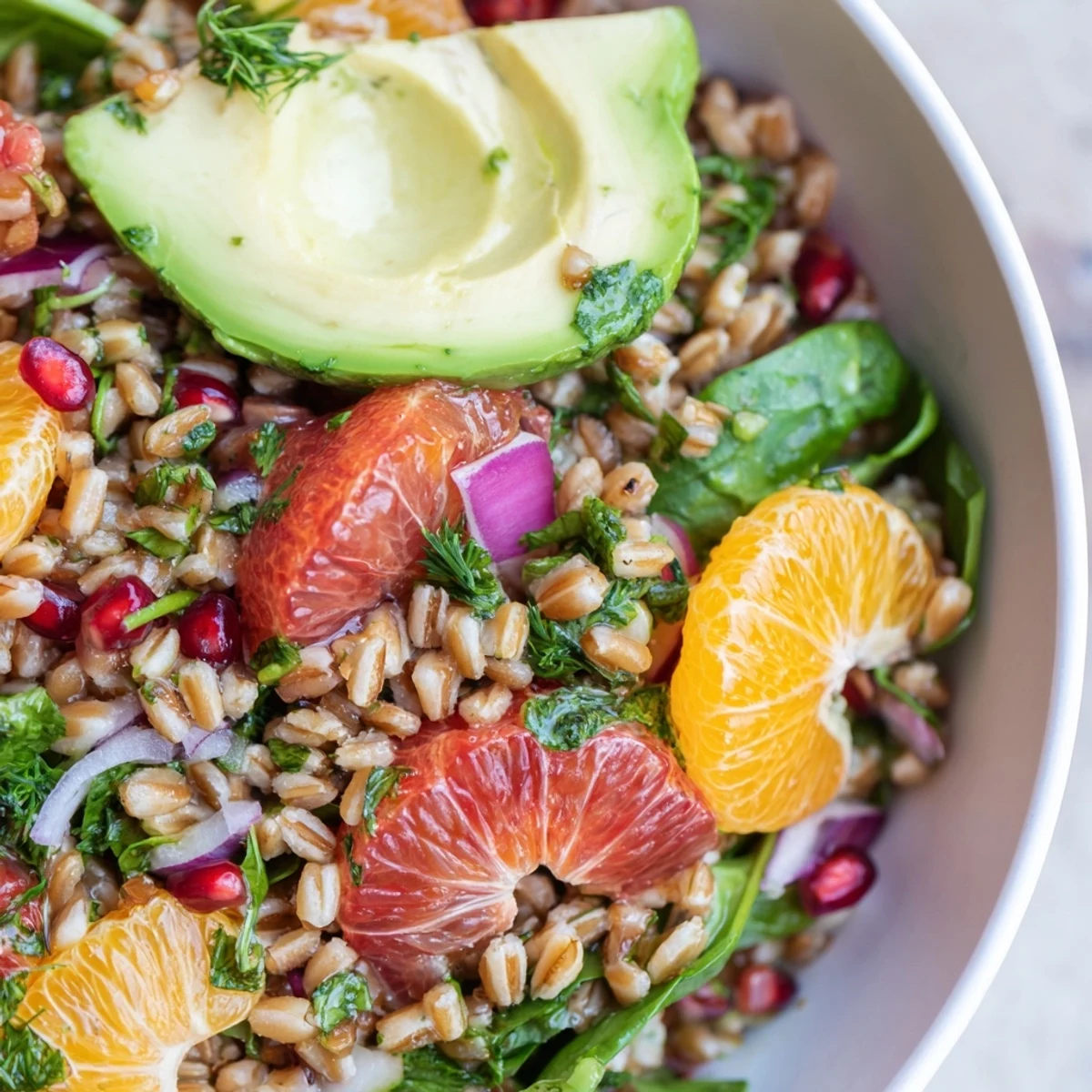 Nutty farro tossed with juicy orange segments and herbs in this colorful grain bowl