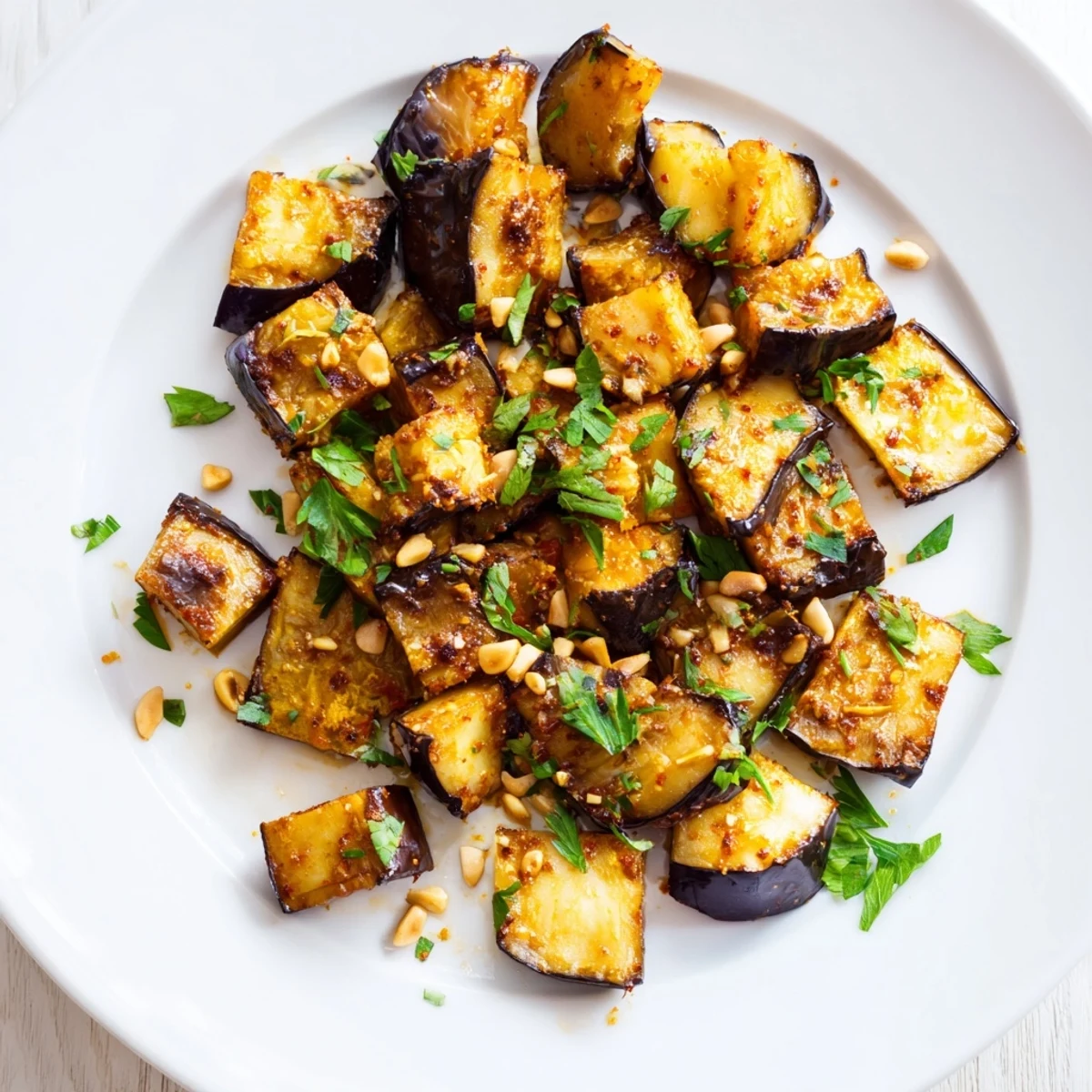 Tender smoky roasted eggplant cubes glistening with olive oil and dusted with vibrant red paprika seasoning