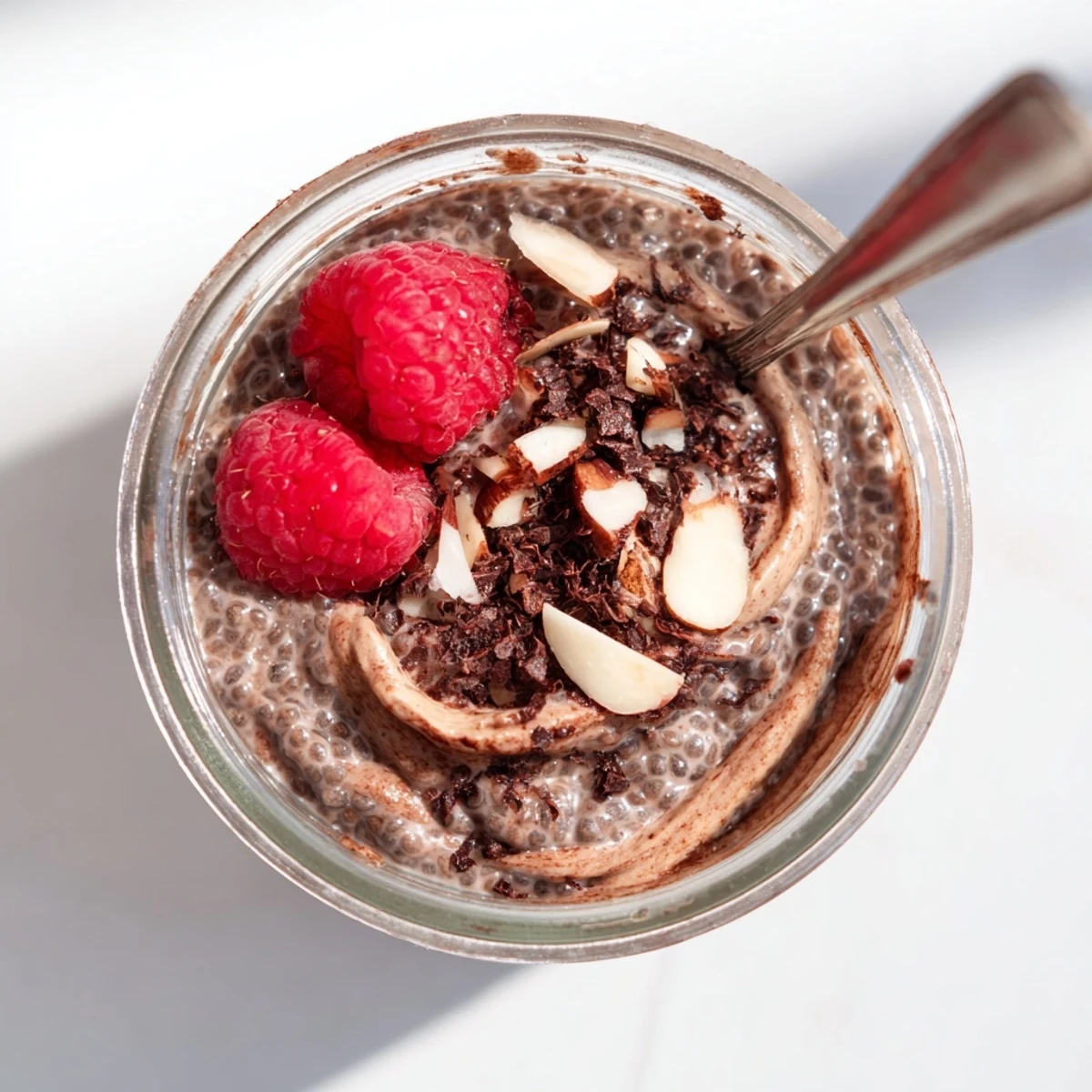 Creamy Cocoa Almond Butter Chia Delight layered in jars with fresh berries
