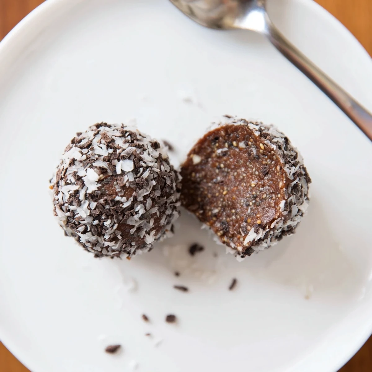 Bite-sized Cocoa Almond Butter Coconut Chia Treat plated with toasted almonds for crunch