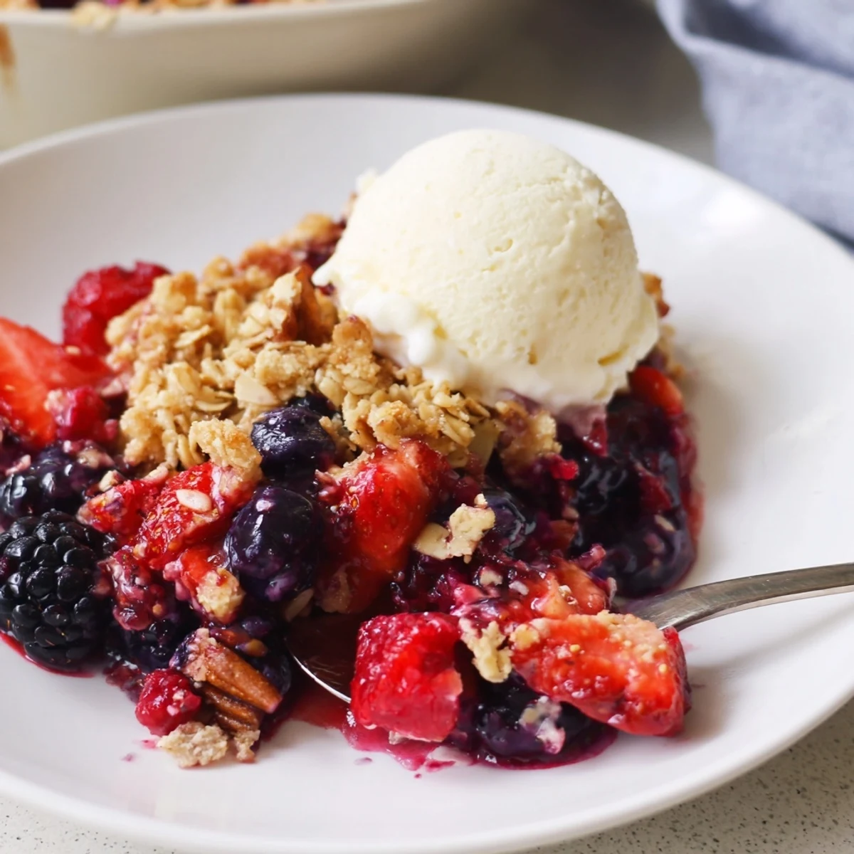 Vanilla Maple Berry Bake cooling in a baking dish, steam rising, crumble crisp