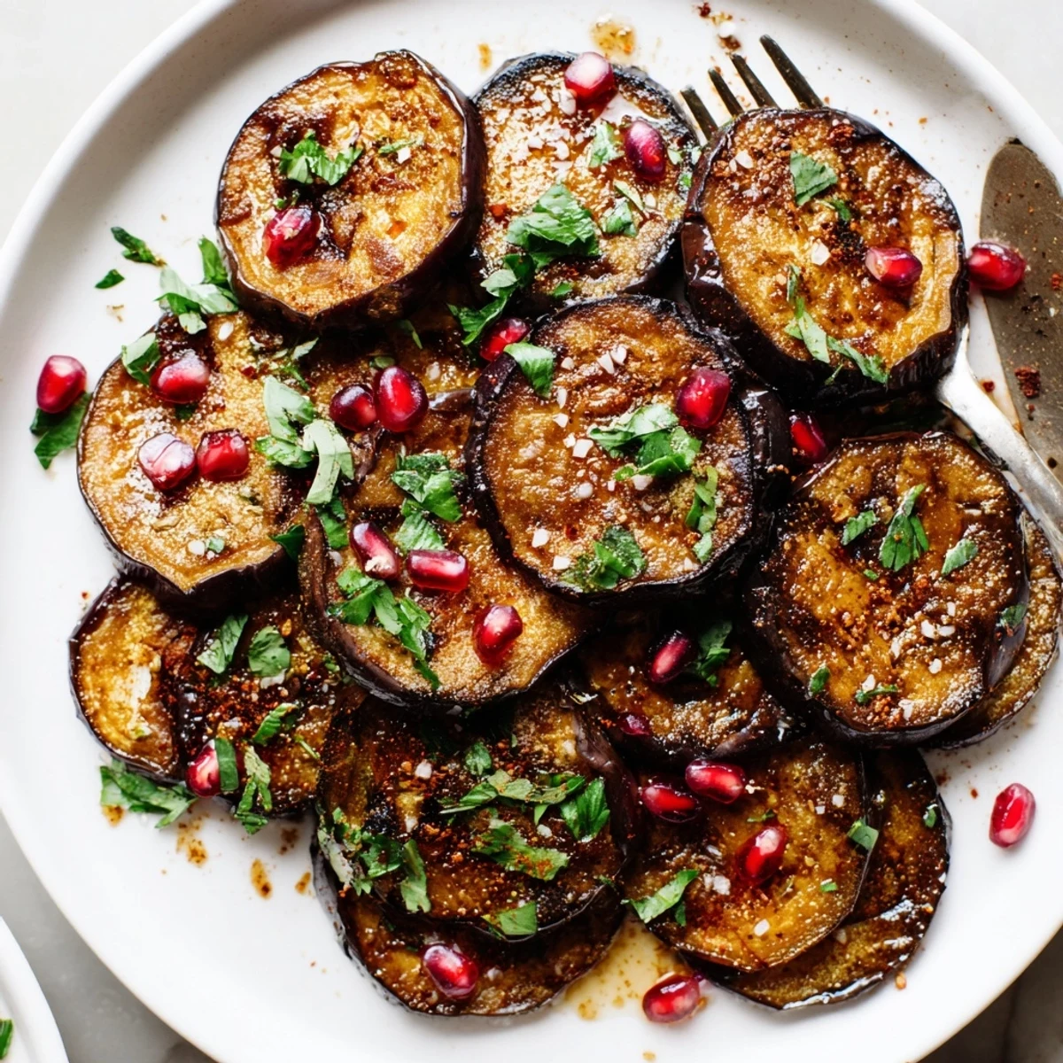 Warm Smoky Roasted Eggplant Rounds drizzled with olive oil and tahini.