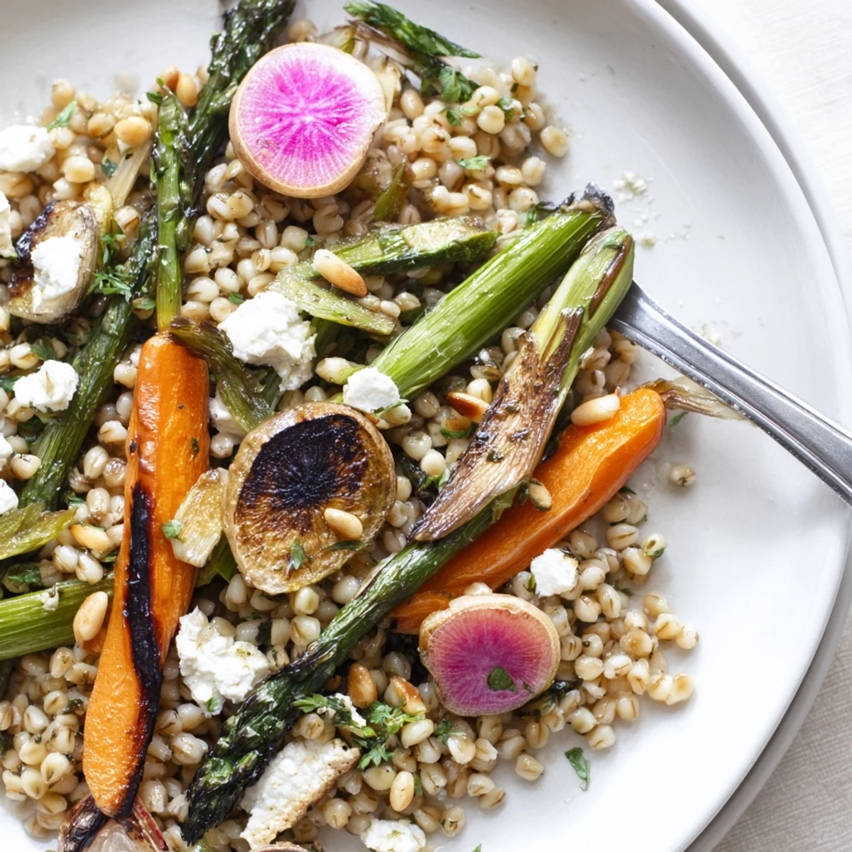 Bowl of Warm Barley and Roasted Spring Vegetable Salad with zesty lemon-herb dressing