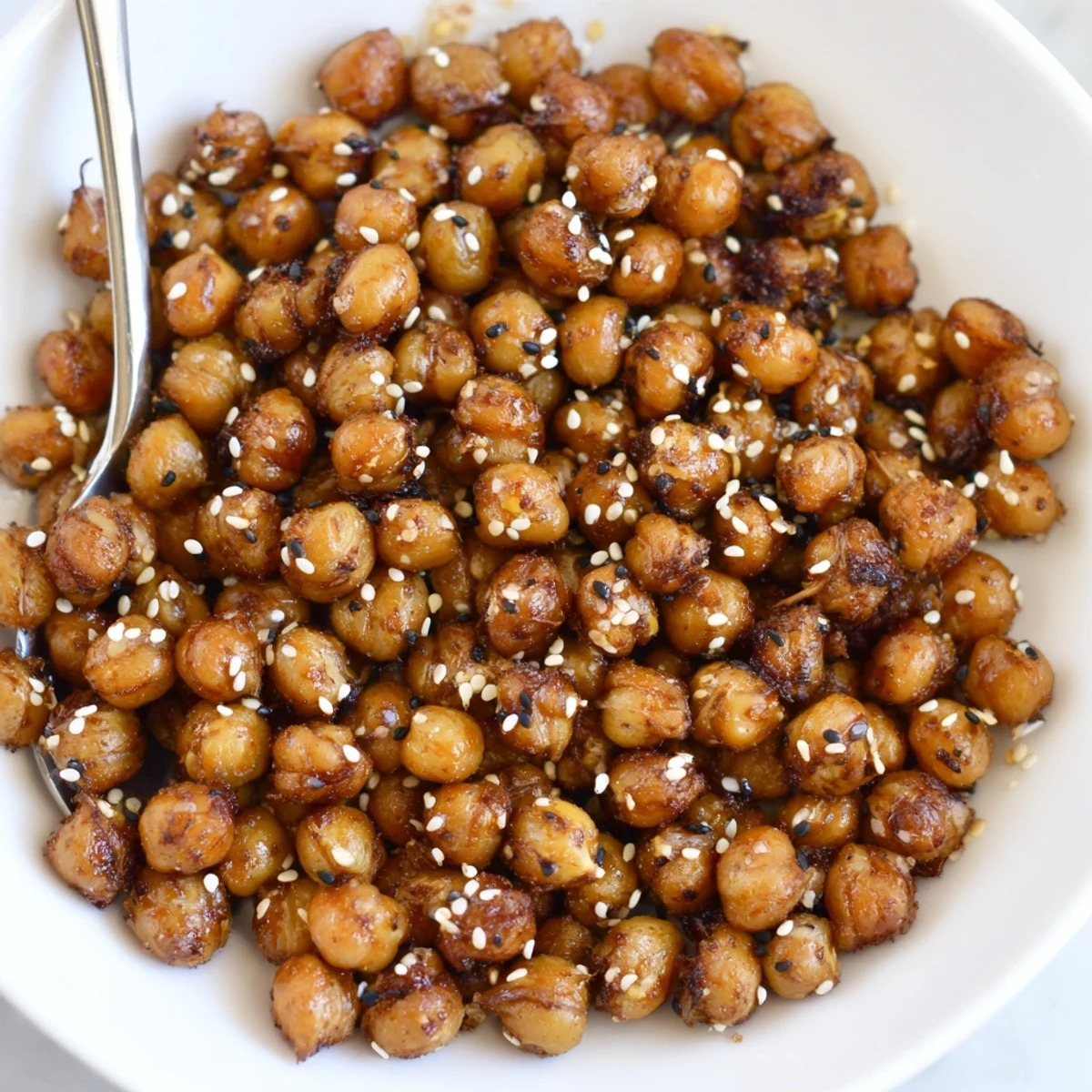 Fresh from the oven Crispy Chili Sesame Chickpea Crunch on parchment, smoky aroma