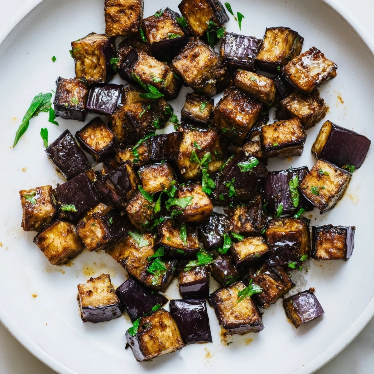 Smoky Roasted Eggplant Cubes gleaming with golden edges, perfect hot side dish.