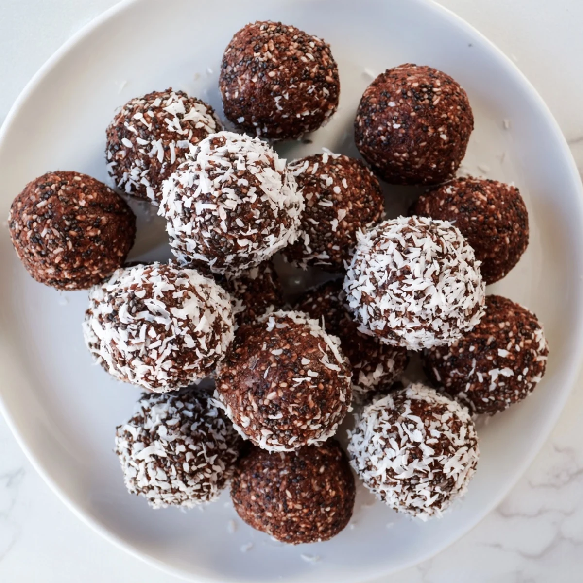 Homemade cocoa coconut cashew chia bliss energy balls dusted with coconut flakes