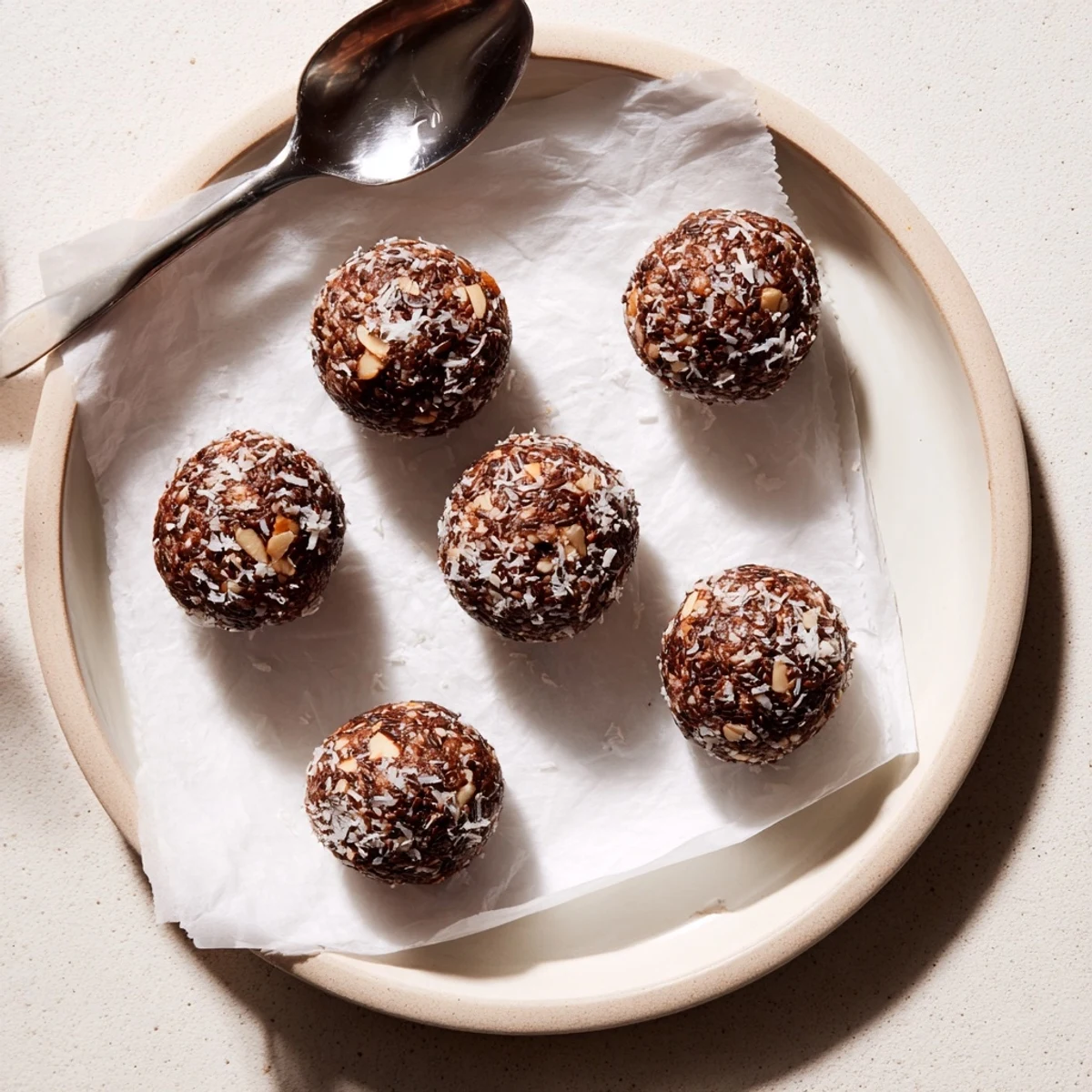 Cocoa Almond Coconut Chia Treat on parchment, glossy chocolate sheen, crunchy almonds.