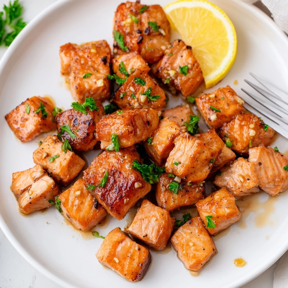 Skewered Lemon Garlic Glazed Salmon Bites with bright citrus aroma and sheen.