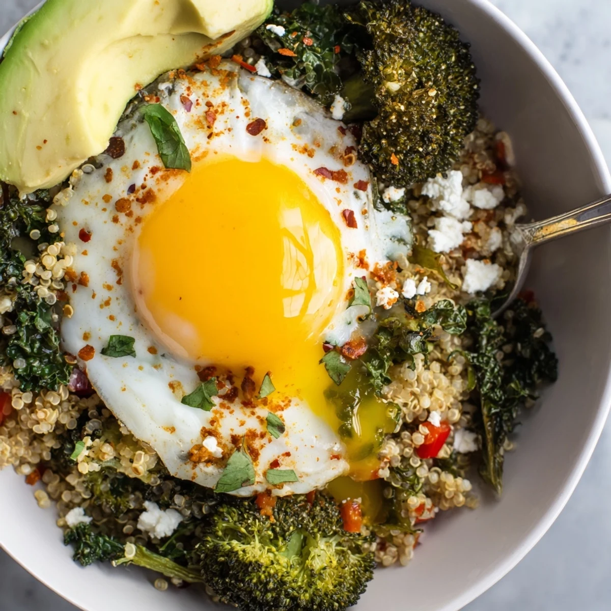 Hearty Savory Broccoli and Kale Quinoa Breakfast Bowl garnished with parsley and lemon