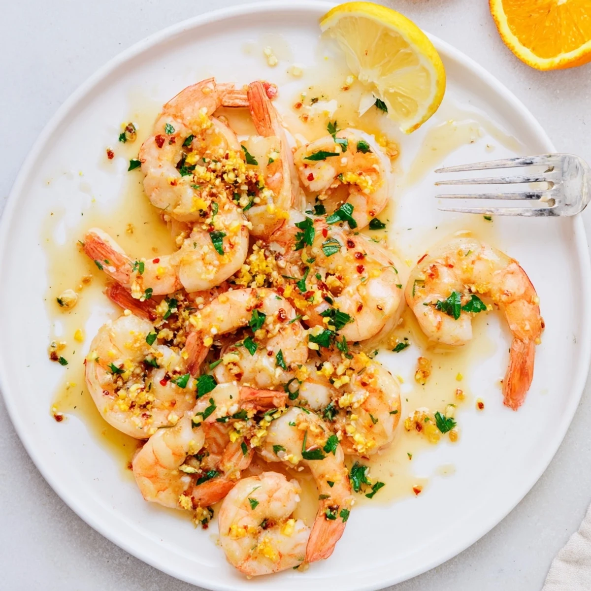 Vibrant citrus honey glazed shrimp skillet with herbs and citrus wedges ready for dinner