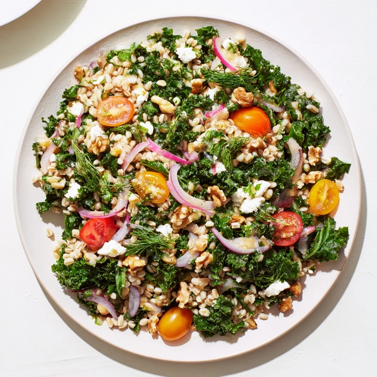 Close-up of citrus herb barley and kale salad with chopped parsley, dill, and mint leaves on top