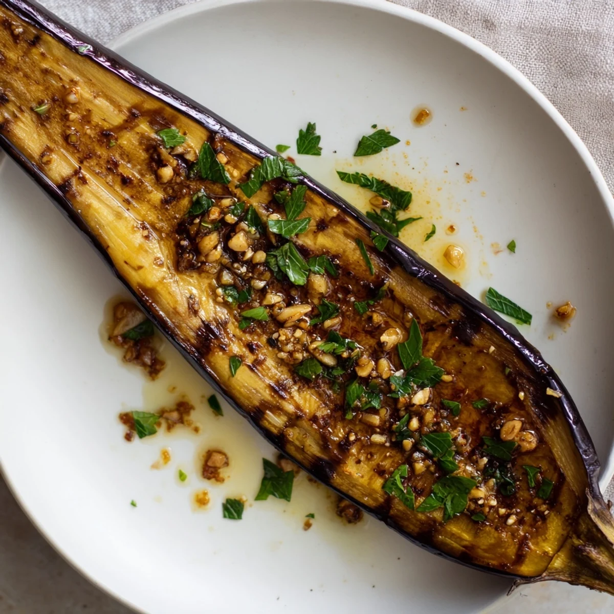 Oven-browned Smoky Roasted Eggplant Spears resting on parchment, garlicky scent.