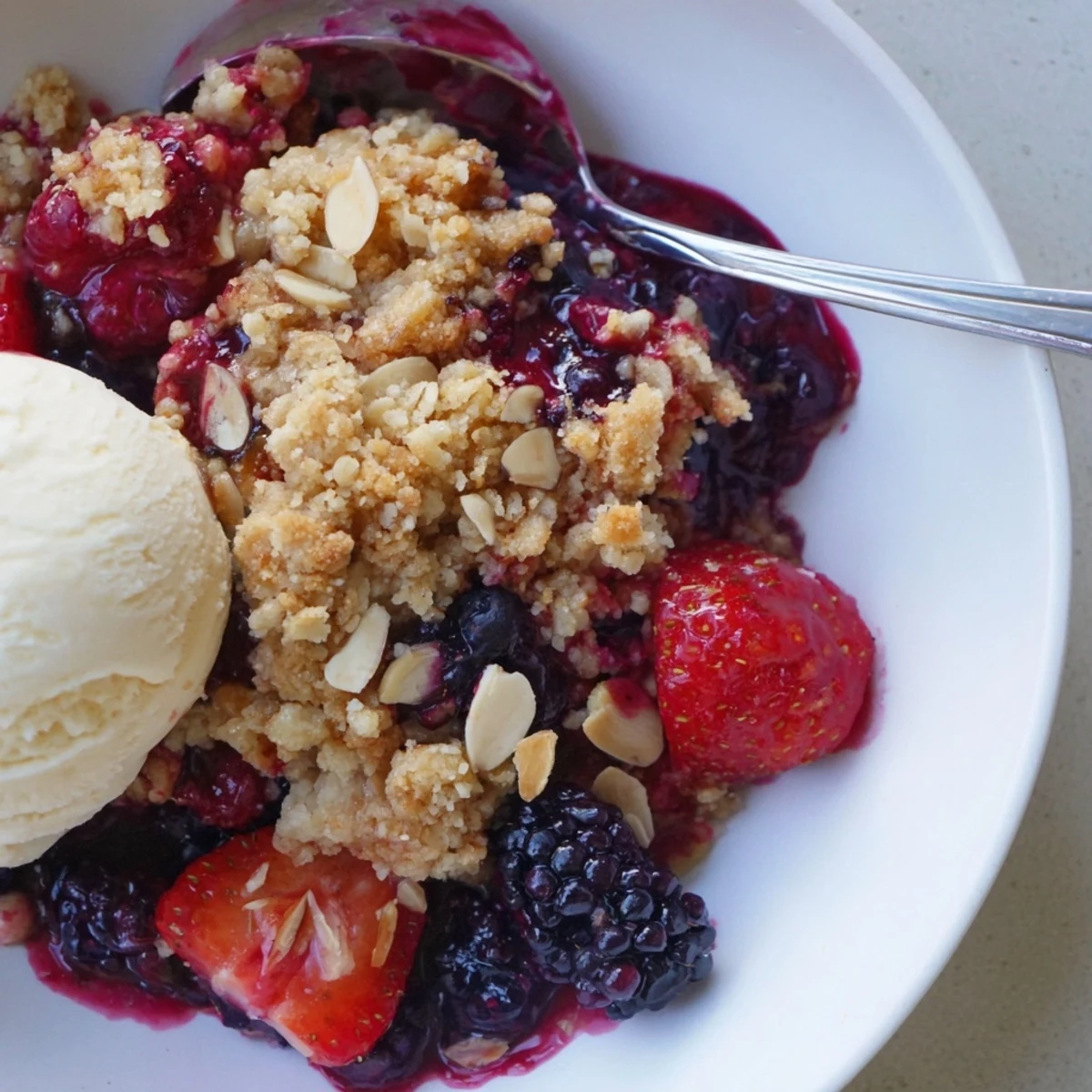 Crisp almond crumble crowns juicy berries in Vanilla Almond Berry Crumble, warm and fragrant