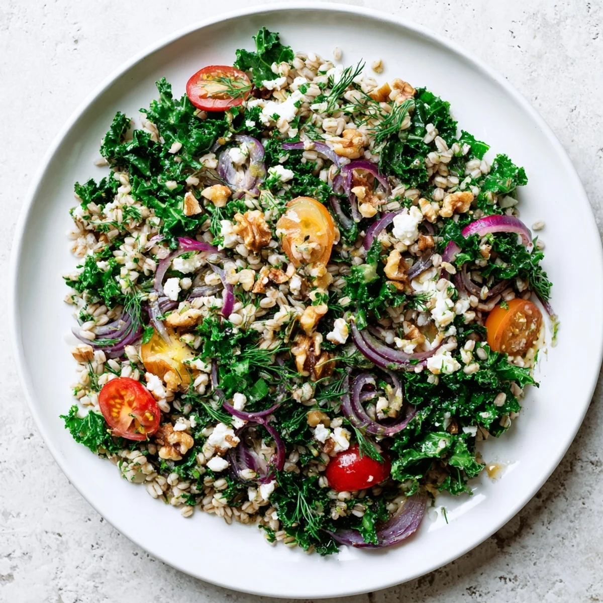 Close-up of citrus herb barley and kale salad with chopped parsley, dill, and mint leaves on top