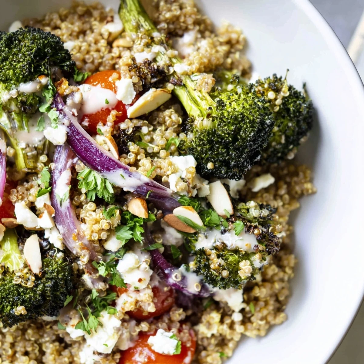 Golden roasted broccoli and fluffy quinoa tossed in creamy lemon tahini dressing served warm