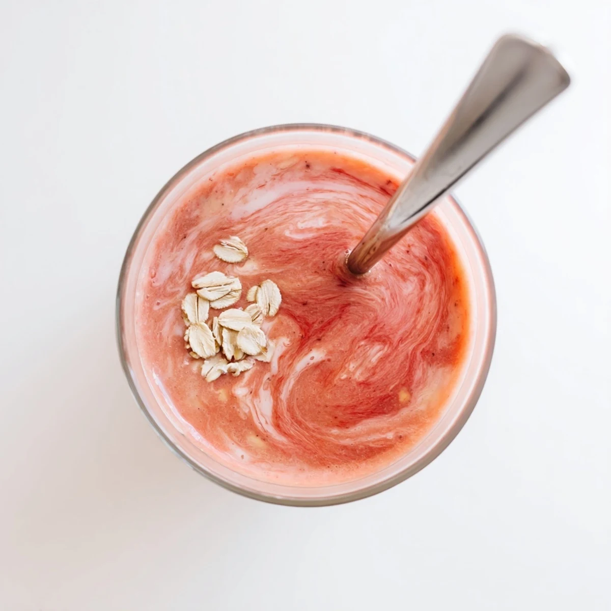 Vibrant peach raspberry oat smoothie blended until smooth with oats for a nutritious breakfast