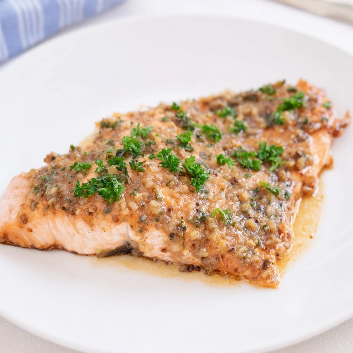 Close-up of honey garlic glazed salmon skillet served with fresh lemon wedges