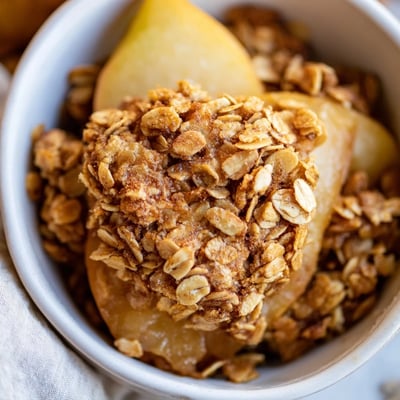 Freshly baked Oat Topped Maple Almond Crisp features tender sliced apples and a crunchy oat and almond topping.