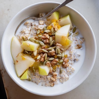Pear Ginger Overnight Oats Bowl with warm spices and a sprinkle of crystallized ginger.