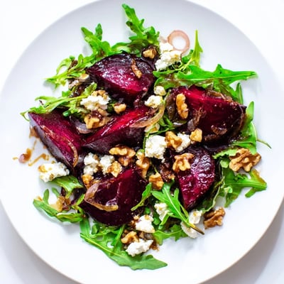Warm Maple roasted beet and arugula salad topped with crumbled goat cheese and balsamic vinaigrette.