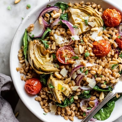 Warm Farro and Roasted Artichoke Salad served warm, nutty farro tossed with baby spinach