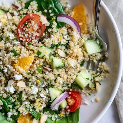A chilled Citrus Herb Quinoa and Spinach Bowl tossed in lemony dressing